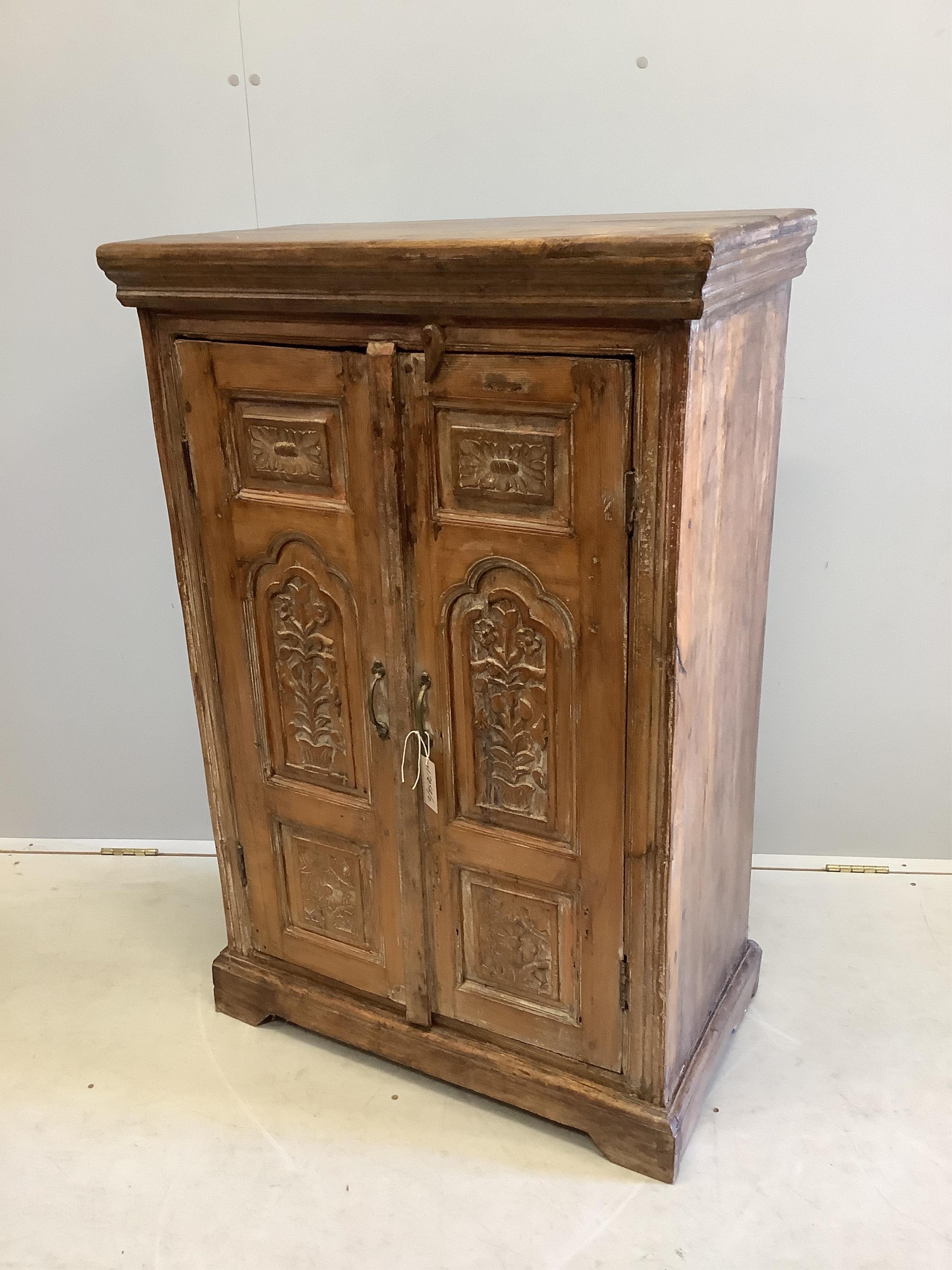 An Indonesian carved hardwood two door side cabinet, width 74cm, depth 39cm, height 112cm